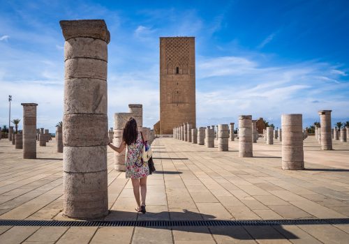 A female tourist enjoying the beautiful view of Tour Hassan in Rabat, Morocco